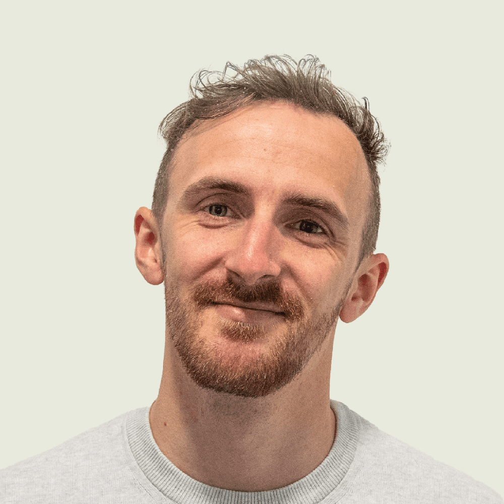 Portrait of a person in dark clothing speaking on a phone